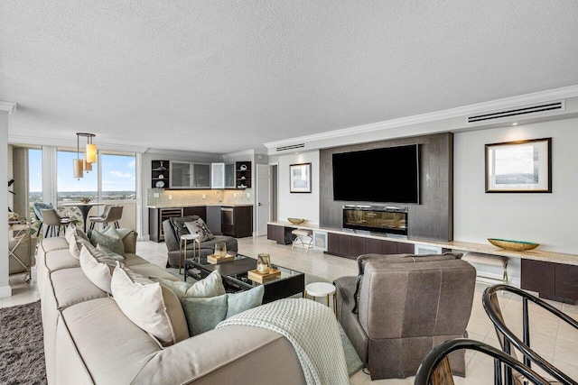 tiled living room featuring a fireplace, crown molding, a textured ceiling, a wall of windows, and beverage cooler