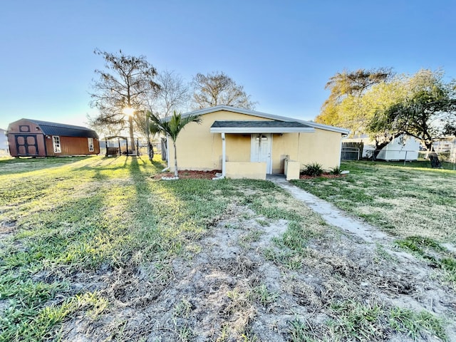 exterior space featuring a yard and a storage shed