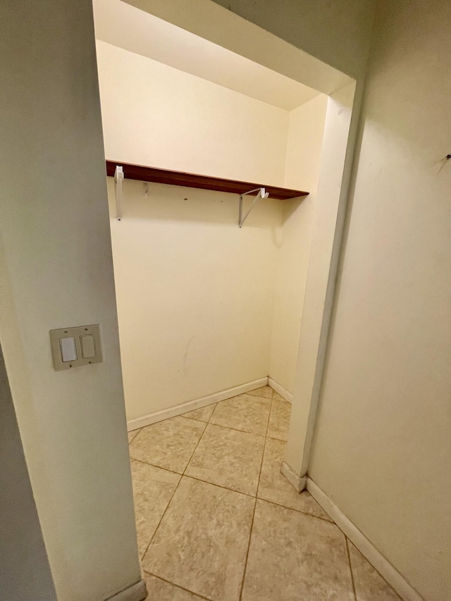 spacious closet with light tile patterned floors