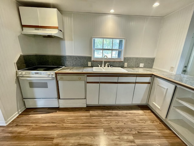 kitchen featuring sink, white cabinets, white appliances, and light wood-type flooring