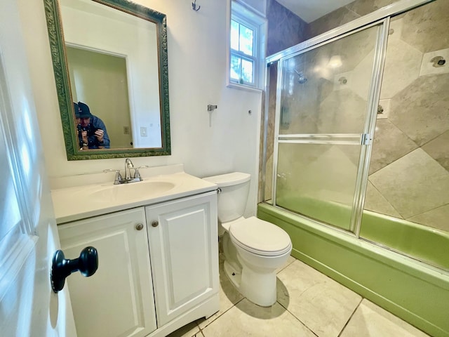 full bathroom with tile patterned flooring, vanity, toilet, and enclosed tub / shower combo