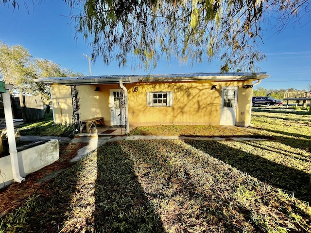 back of house with a yard