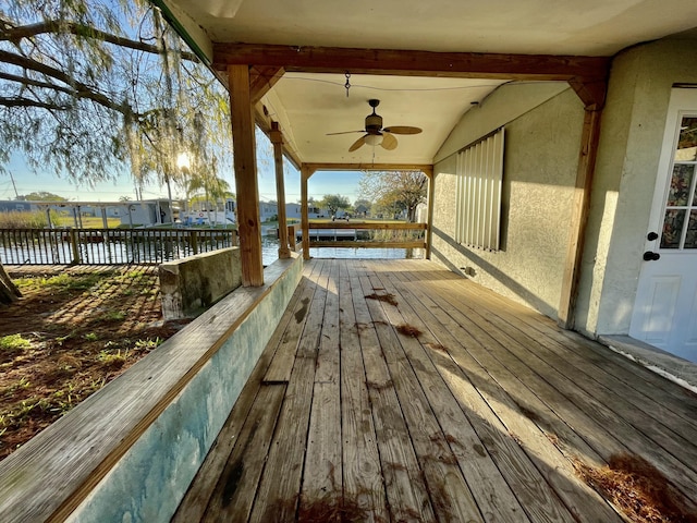 wooden terrace featuring ceiling fan and a water view