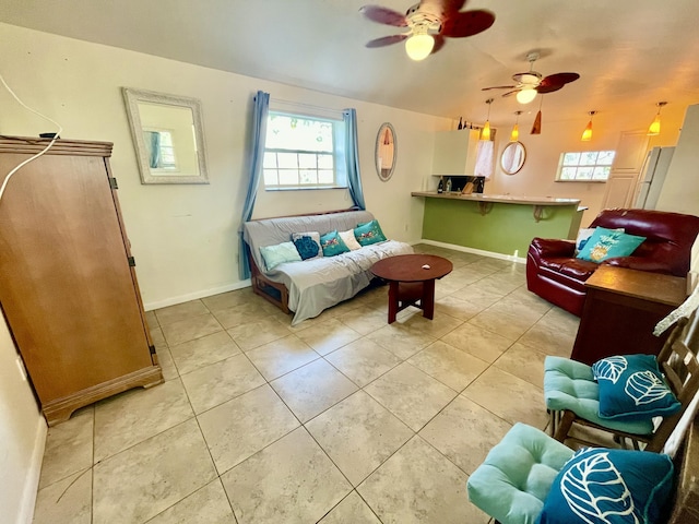 tiled living room with ceiling fan