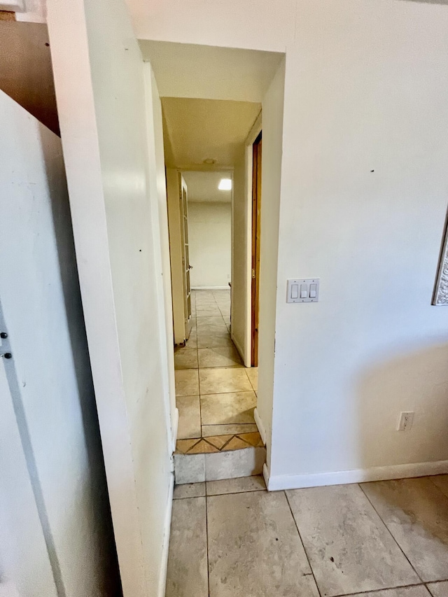 hallway with light tile patterned floors