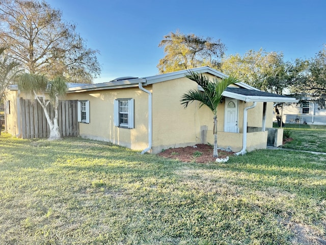 view of property exterior featuring a lawn