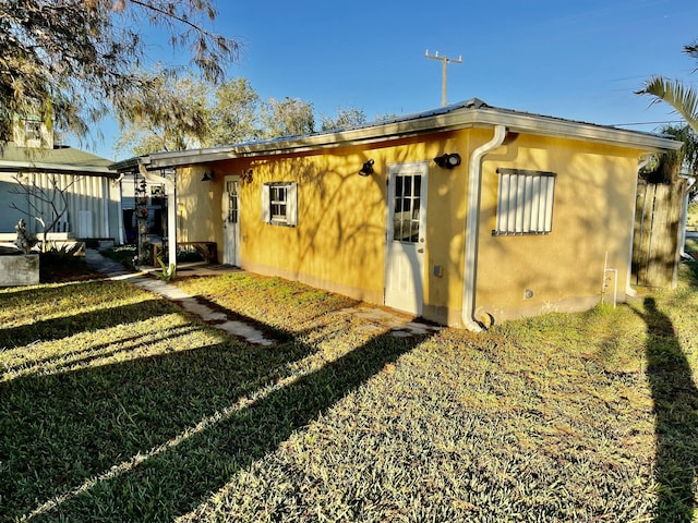 back of house with a lawn