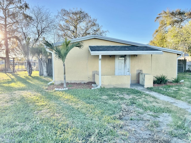 rear view of house featuring a yard