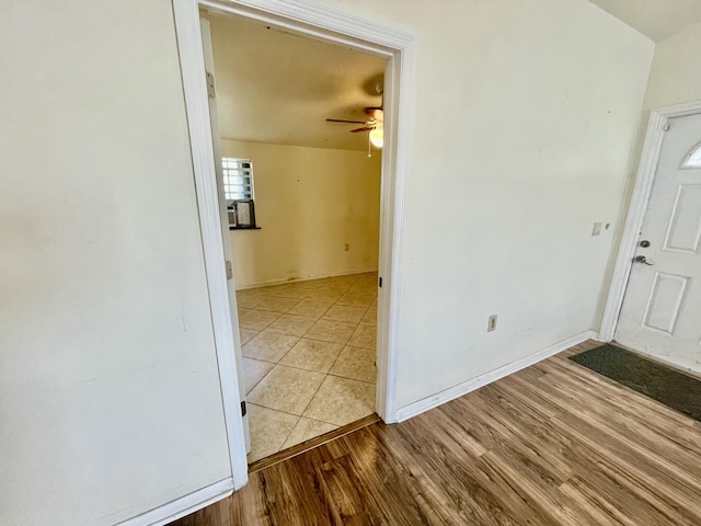 foyer with ceiling fan and light wood-type flooring