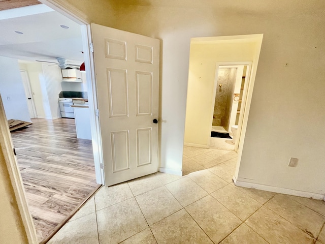 hallway featuring light tile patterned floors