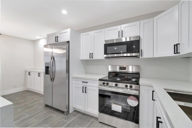 kitchen with recessed lighting, light countertops, white cabinets, and stainless steel appliances