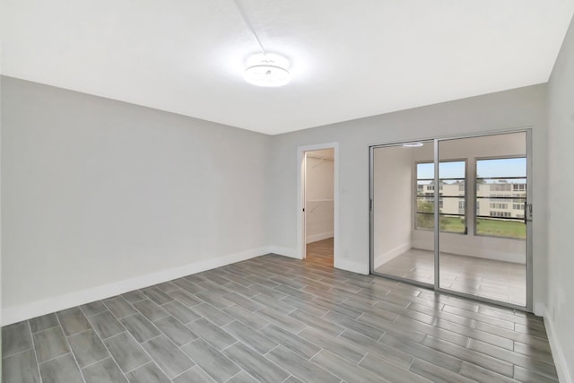 unfurnished bedroom with baseboards and a closet