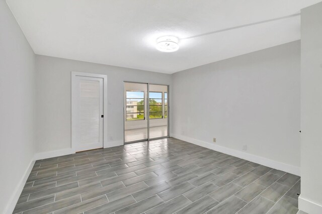 unfurnished room with baseboards