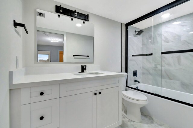 bathroom featuring vanity, toilet, and a shower with door