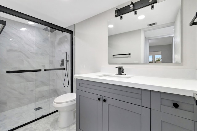 bathroom with toilet, vanity, a marble finish shower, and visible vents