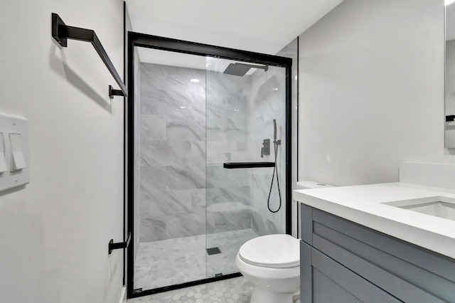 full bath featuring toilet, vanity, and a marble finish shower
