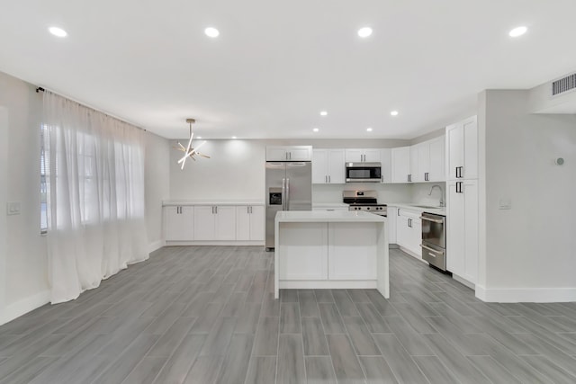 kitchen featuring a sink, recessed lighting, light countertops, and appliances with stainless steel finishes