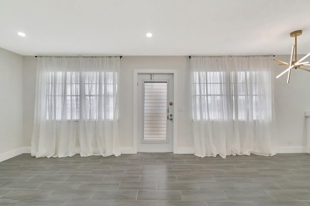 interior space with baseboards and plenty of natural light