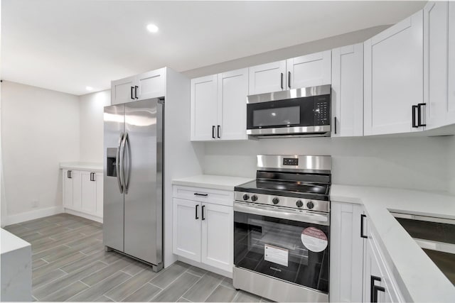kitchen featuring white cabinetry, light countertops, recessed lighting, and stainless steel appliances