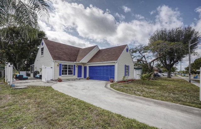 view of front of house with a front yard and a garage