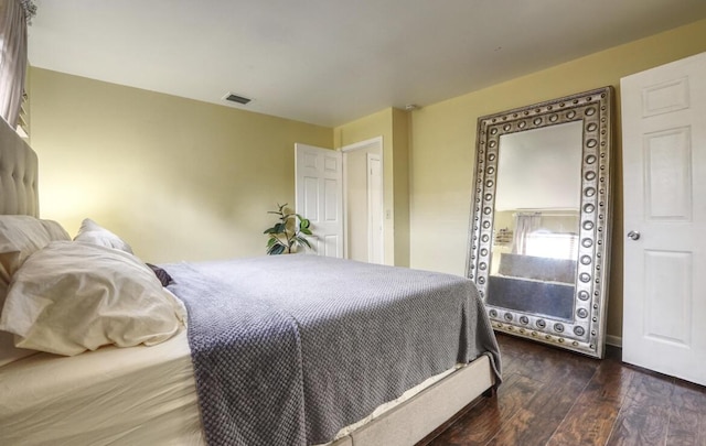 bedroom featuring wood-type flooring and visible vents