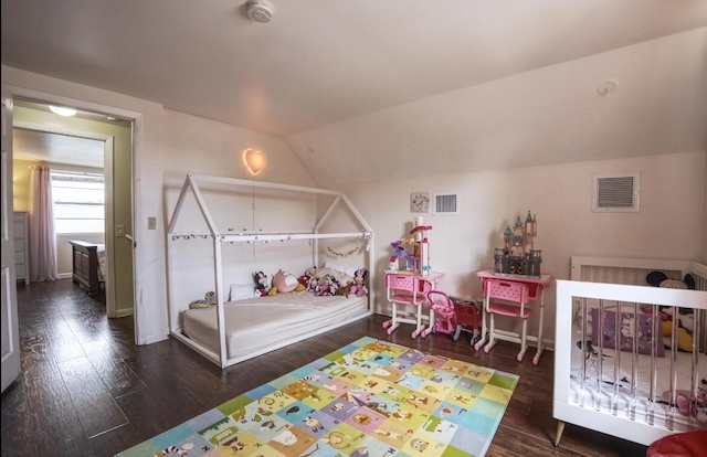 bedroom with lofted ceiling, dark wood-style flooring, and visible vents