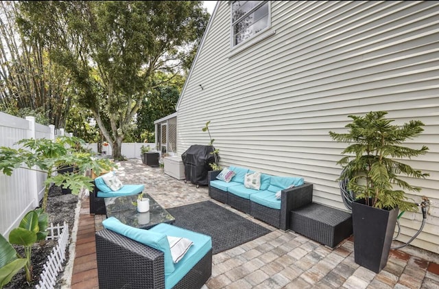 view of patio with a fenced backyard, outdoor lounge area, and area for grilling