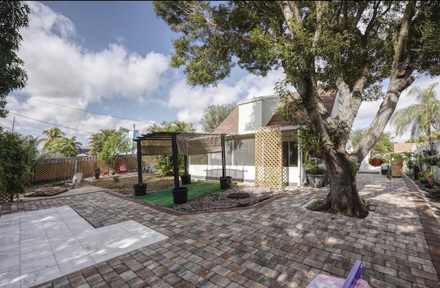 view of patio with an outdoor fire pit, a fenced backyard, and a pergola