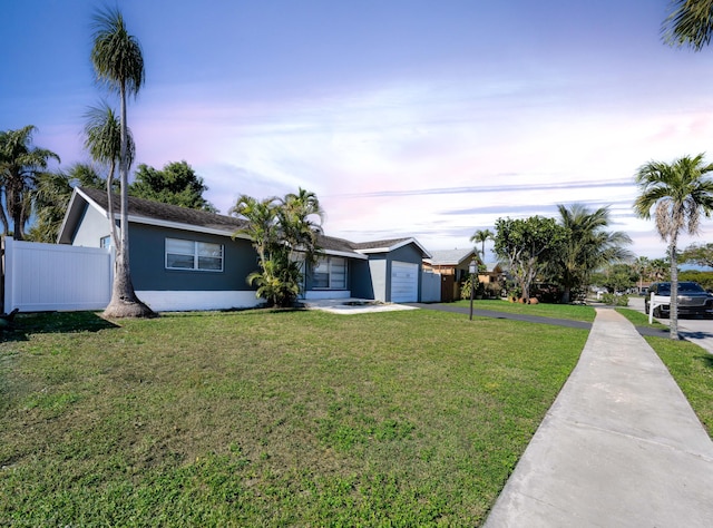 view of front facade featuring a yard and a garage