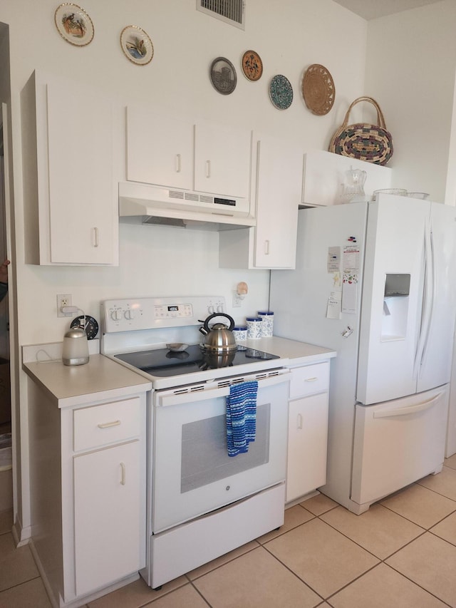 kitchen featuring white cabinetry, white appliances, and light tile patterned floors