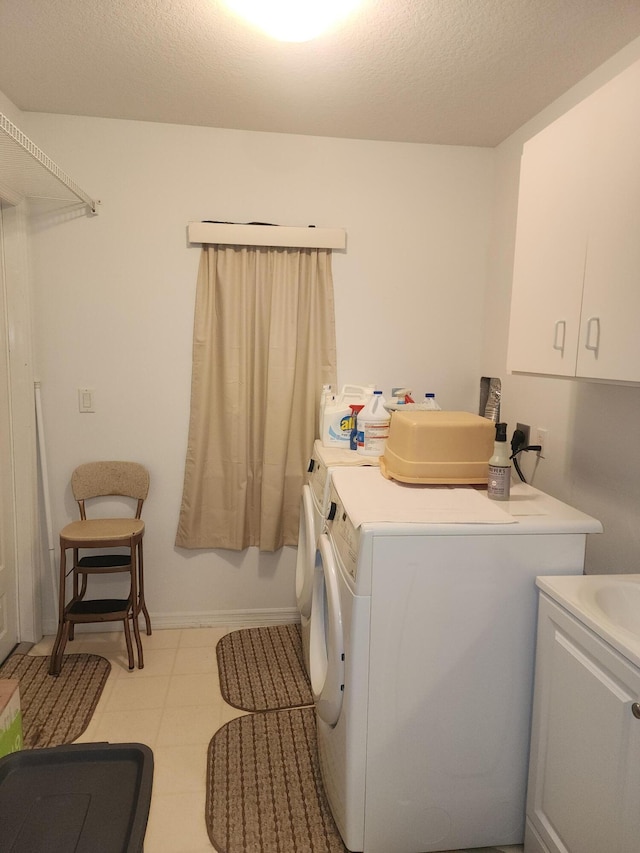 laundry area featuring washing machine and dryer and a textured ceiling