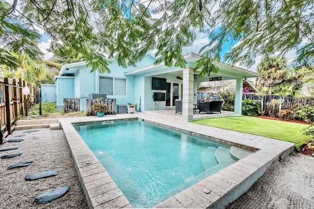 view of pool with a patio area and a lawn