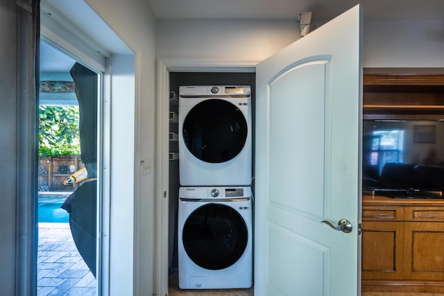 clothes washing area with stacked washer / drying machine