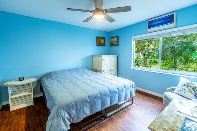 bedroom with dark wood-type flooring and ceiling fan