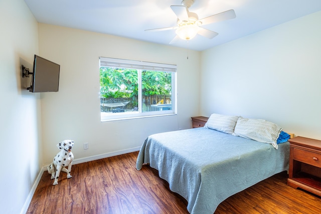 bedroom with wood finished floors, baseboards, and ceiling fan