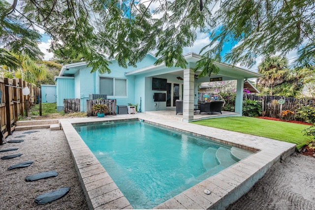 view of pool with a yard and a patio