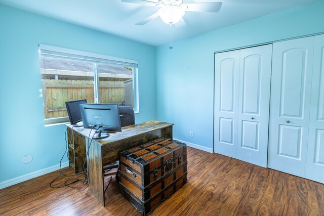 office space featuring a ceiling fan, wood finished floors, and baseboards