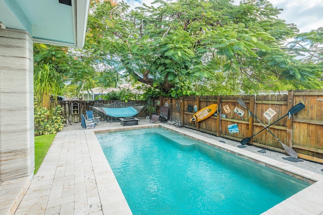 view of pool with a fenced backyard and a patio