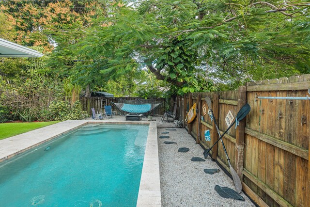 view of swimming pool with a fenced backyard