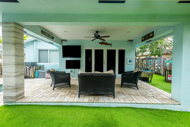 view of patio with fence, a ceiling fan, and an outdoor living space