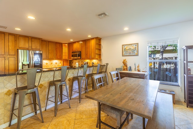 kitchen with stainless steel appliances, recessed lighting, light tile patterned floors, decorative backsplash, and open shelves