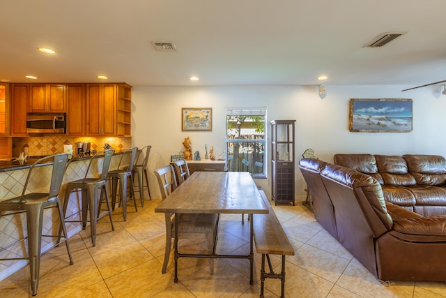 living area featuring recessed lighting and light tile patterned floors