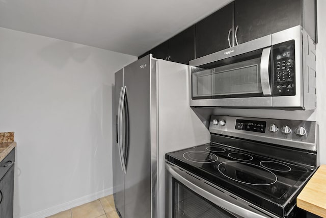 kitchen with stainless steel appliances and light tile patterned floors