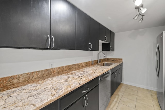 kitchen with sink, stainless steel appliances, light stone counters, and light tile patterned flooring