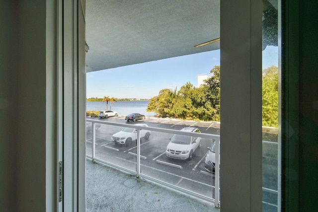 balcony featuring a water view