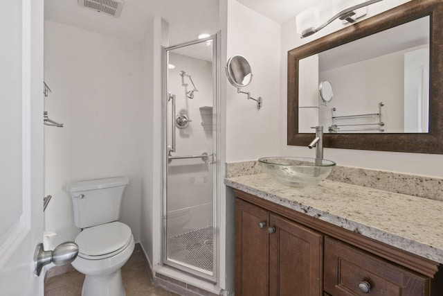 bathroom featuring a shower with shower door, tile patterned floors, vanity, and toilet