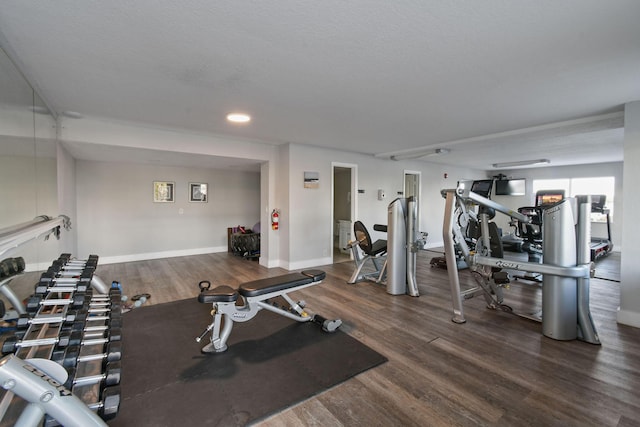 exercise room featuring a textured ceiling and hardwood / wood-style flooring