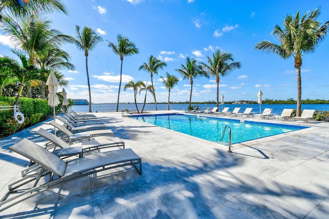 view of pool featuring a patio area and a water view