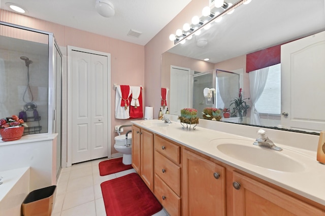 bathroom featuring toilet, tile patterned flooring, walk in shower, and vanity