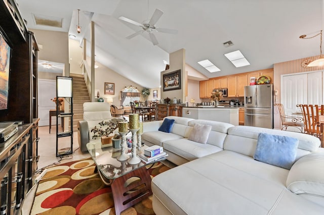 living room with ceiling fan and lofted ceiling